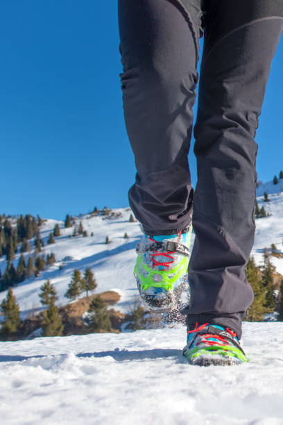 istock Walk on the snow with boots and crampons 1205203109