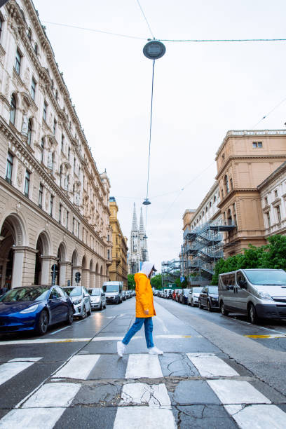 istock woman crossing street old church towers on background 1205203473