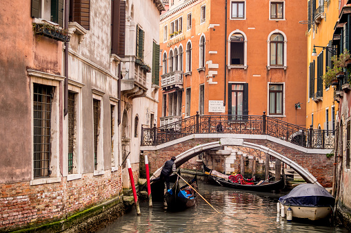 Venice, Italy, Feb 26 - A view of a canal in the heart of Venice with a gondola in the foreground. Venice is one of the most loved and visited Italian cities by the millions of tourists who visit this Mediterranean country every year.