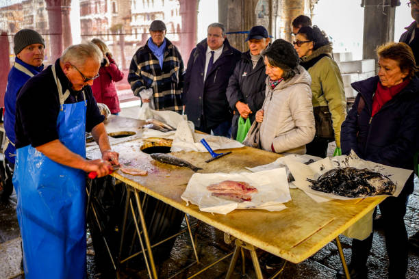 some customers in the venice fish market near the rialto bridge - market rialto bridge venice italy italy imagens e fotografias de stock