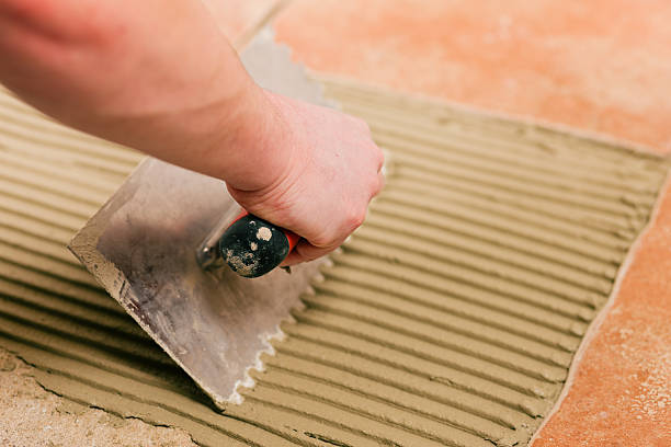 istock Tiler tiling tiles on the floor 120520385