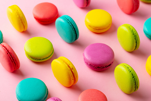 Macaroons dessert on pink background. Flat lay composition. Close up.