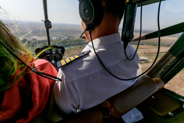 istock Pilot flying a helicopter with a passenger in cockpit 1205205892