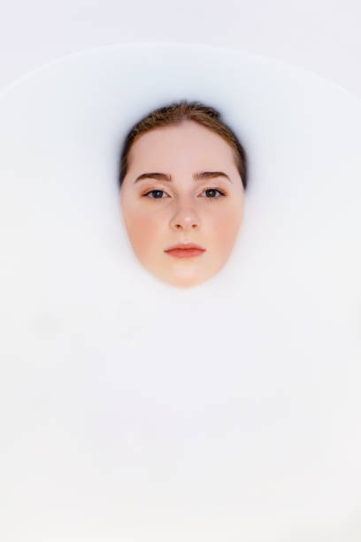 istock Pretty girl in bath with milk. 1205205953