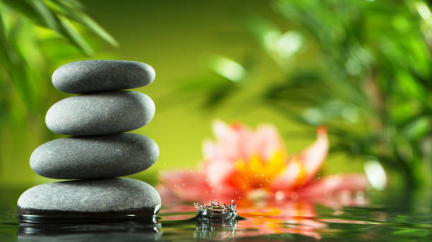 istock Dripping drops of water with black lava stones 1205206733