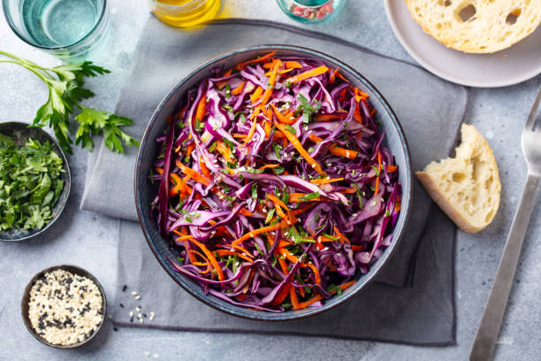 Red cabbage salad, Coleslaw in a bowl. Grey background. Top view. Red cabbage salad, Coleslaw in a bowl. Grey background. Top view. coleslaw stock pictures, royalty-free photos & images