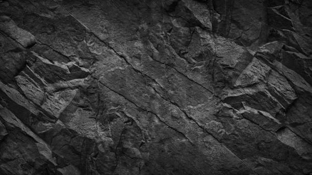 istock Black grunge background. Dark gray rock texture. Cracked rough stone surface. 1205209229