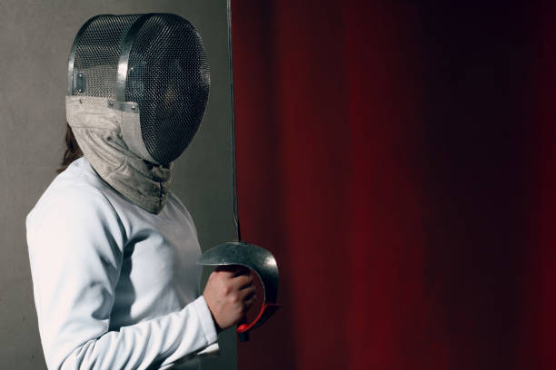 istock Fencer woman with fencing sword. 1205209918
