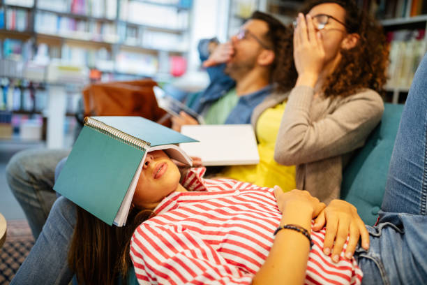 College, study, university and education concept. Group of tired students learning in library College, study, university and education concept. Group of tired exhausted students learning in library male college student sleeping through lecture stock pictures, royalty-free photos & images