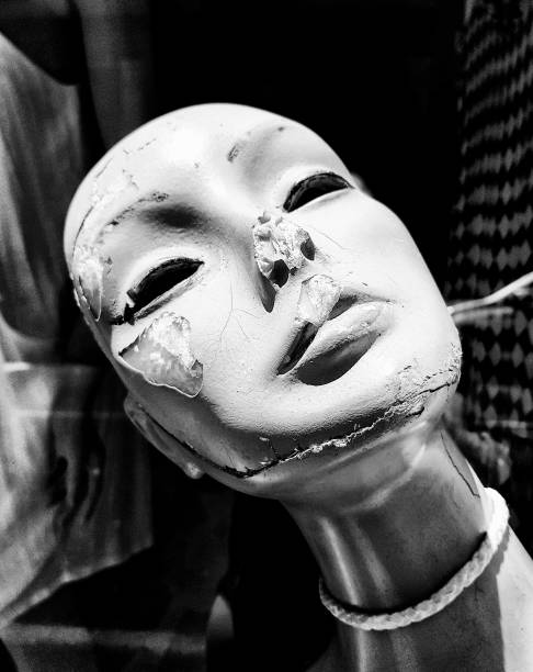 The tragedy of age: a once-beautiful female window mannequin, now discarded, cracked and useless.