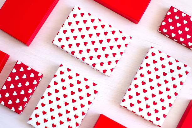 istock Valentine day composition, flat lay top view. White and red gift boxes with white and red heart on white background. Photo template, background, copy space. View from above 1205212536