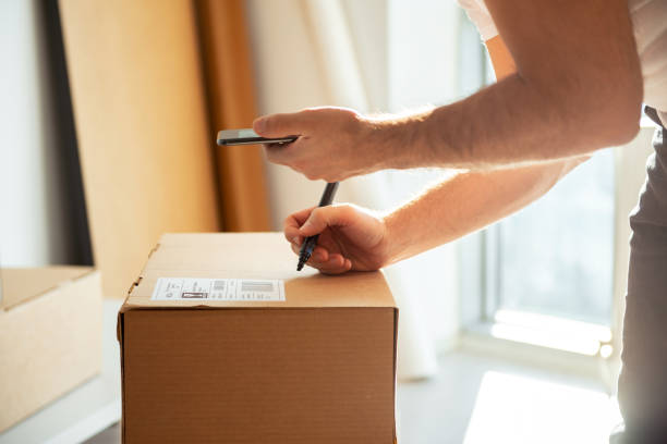 istock Delivery service, scanning a shipping label 1205212680