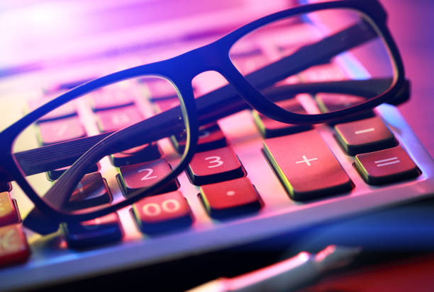 istock Calculator, glasses and pen 1205213453