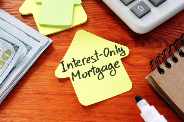 istock Interest Only Mortgage phrase on the paper home. 1205214885
