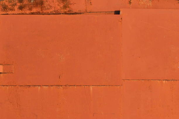 istock Old iron sheet with peeling brown paint and rusty spots 1205214891