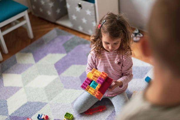 istock Happy little children playing with colorful building blocks 1205215776
