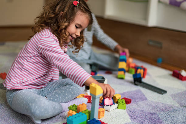 istock Happy little children playing with colorful building blocks 1205215873