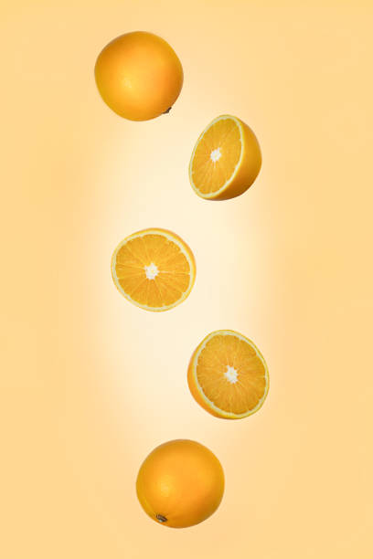 istock Falling orange isolated on a light orange background with clipping path as package design element and advertising. 1205216575