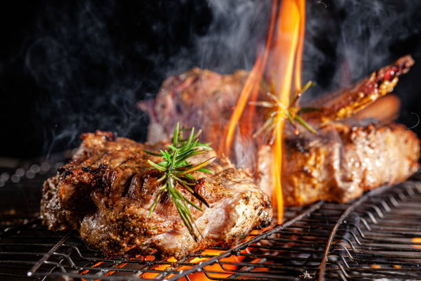 istock Chef cook fries meat, beef steak on an open fire in a restaurant. background image, copy space text 1205217489