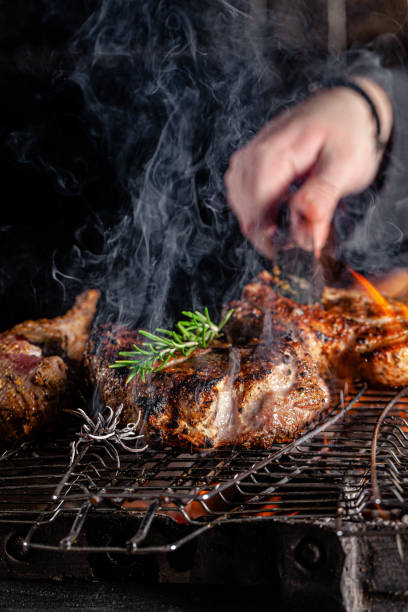 istock Chef cook fries meat, beef steak on an open fire in a restaurant. background image, copy space text 1205217503