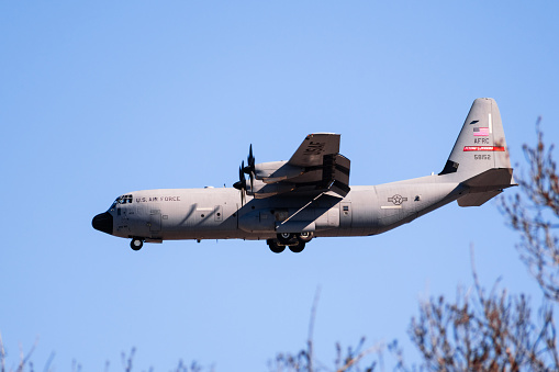 Feb 6, 2020 Mountain View / CA / USA - Lockheed C-130J Hercules aircraft, part of the United States Air Force 815th Airlift Squadron, preparing for landing at Moffett Federal Airfield, Silicon Valley