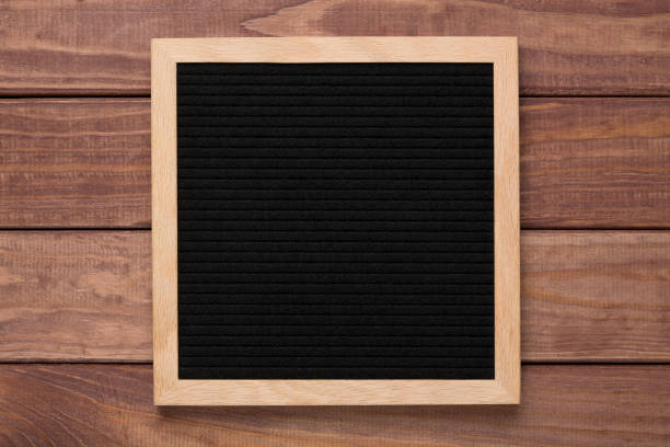 istock Empty black letterboard on wood background. Design mockup 1205220463
