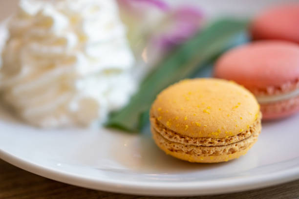 istock Close-up Colorful biscuit macaroons. Sweet macarons on white plates. 1205220586