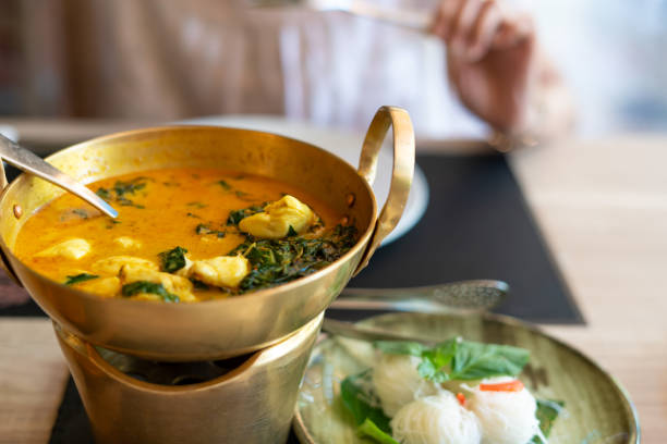 istock Crab curry with betel leaves in a brass pan at restaurant. 1205220717