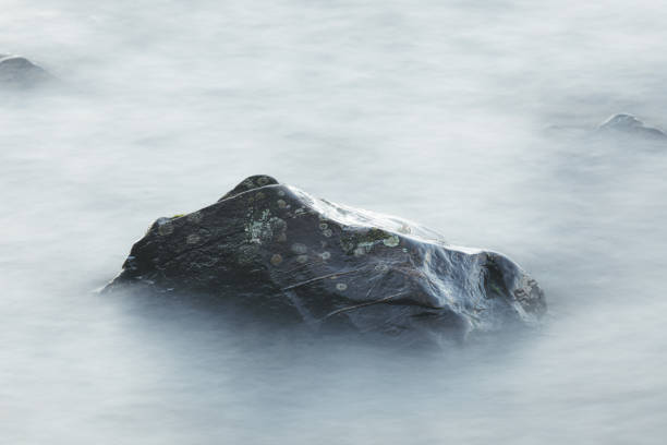 istock Long exposure of waves and rocks at dawn 1205222541
