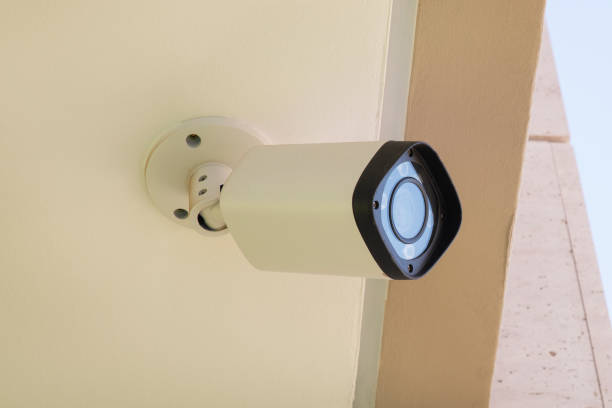 istock Modern CCTV camera mounted on a building wall or ceiling for outdoors surveillance, monitoring streets, homes or offices 1205222544