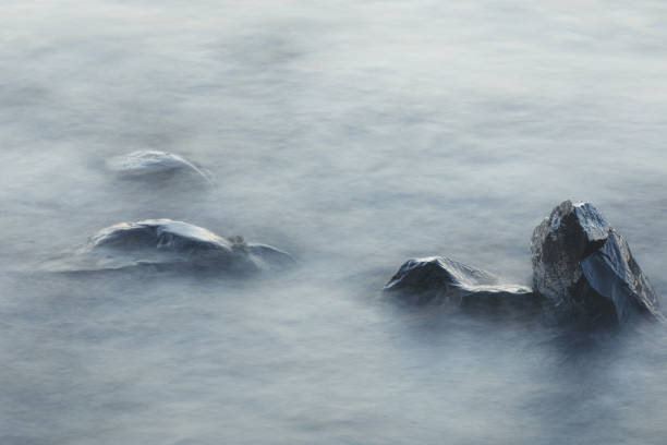 istock Long exposure of waves and rocks at dawn 1205222818