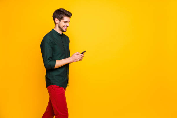 istock Profile side photo of positive cheerful guy have spring weekends go walk use cellpohne texting followers on social networking blogging wear modern good look clothing isolated shine color background 1205223371