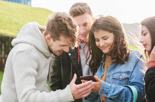 istock Happy friends looking at mobile phone 1205224475