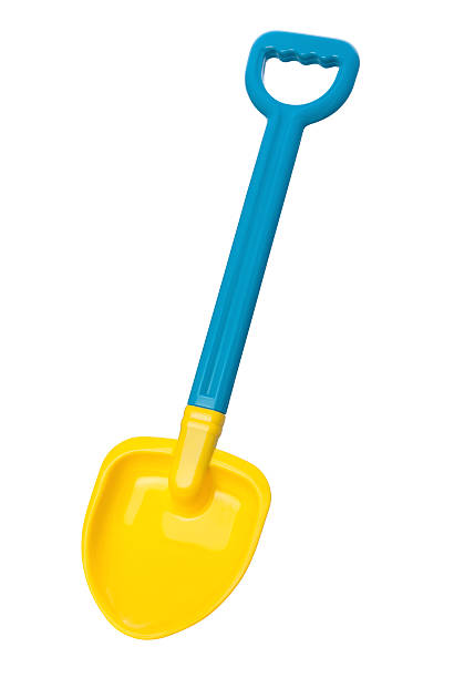 Toy Beach Shovel (clipping path)  Yellow and blue plastic toy Beach Shovel.  This tool can be used by children to shovel sand at the beach.  The image is shown at an angle, and is in full focus from the front to the back.  The subject is isolated on a white background, and includes a clipping path. shovel in sand stock pictures, royalty-free photos & images