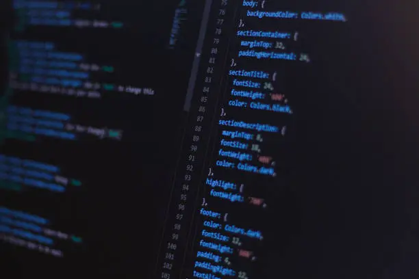 Close-up software developer programming code on screen