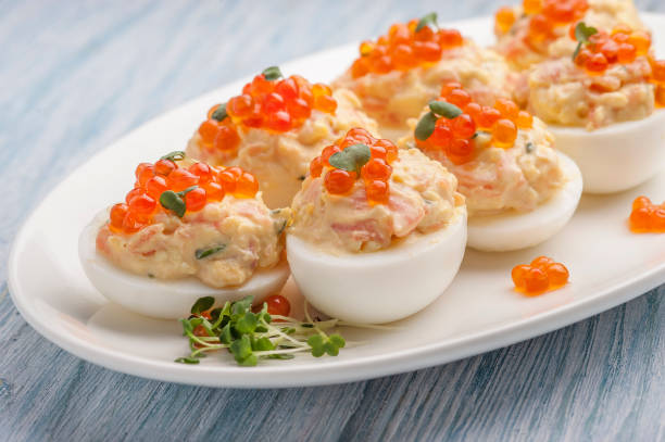 istock Stuffed eggs with red caviar. Traditional festive Russian snack 1205226680