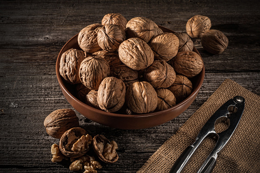 Walnuts in a bowl. Rustic style. Close up and horizontal orientation. \