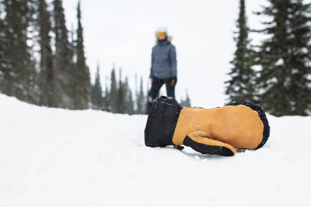 istock Woman on snowboard looking at her lost mitten. 1205227869