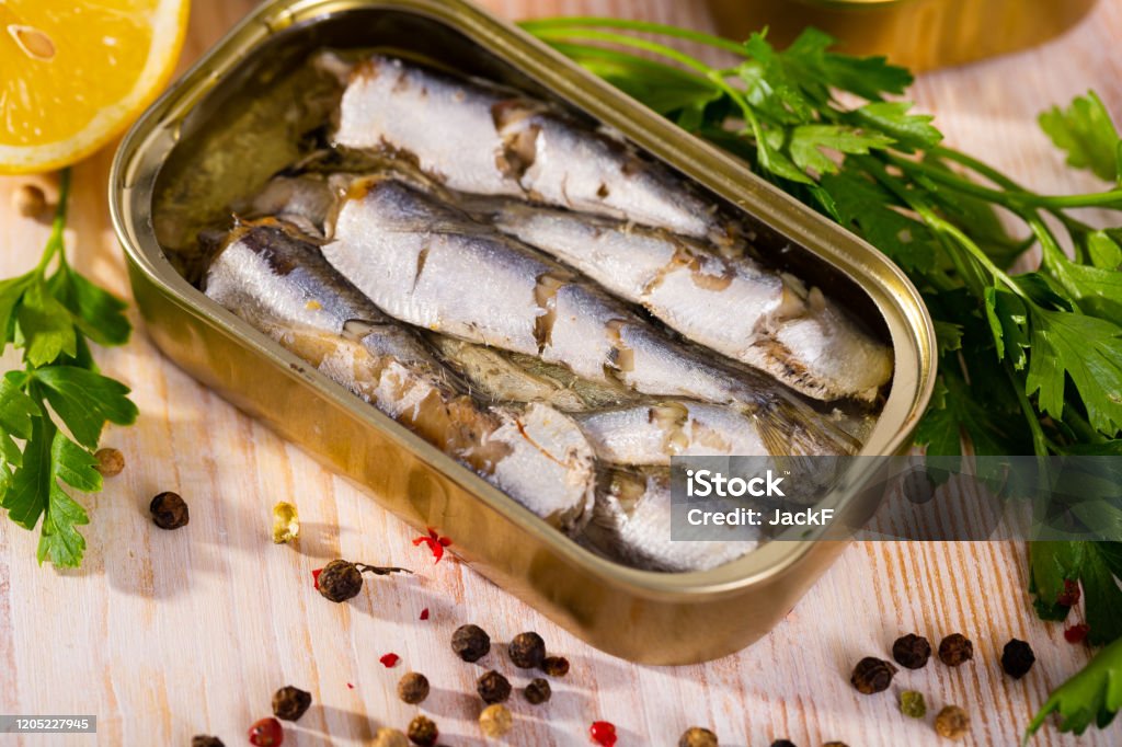 Open can of sardines on table Sardine Stock Photo