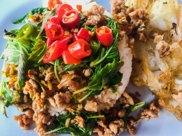 istock Popular Thai Food one dish meal from Fried Basil Pork Topping it with a crispy fried egg is a delicious for lunch or dinner. 1205228554