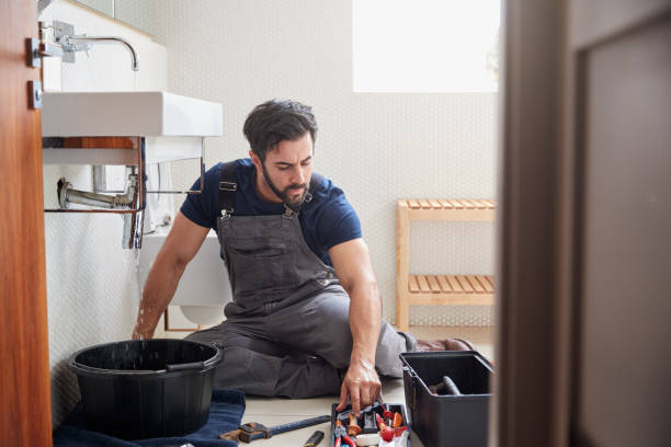 istock Male Plumber Working To Fix Leaking Sink In Home Bathroom 1205228785