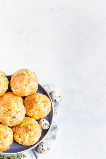 istock Savory muffins with bacon, quail egg, green onion and cheese on a light stone background. Protein breakfast. Paleo or keto diet. 1205229583