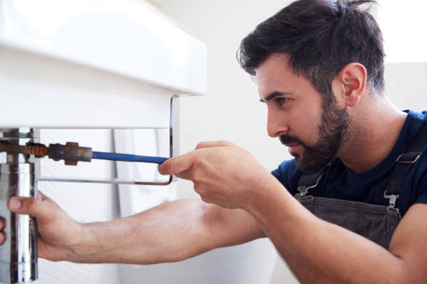 istock Male Plumber Using Wrench To Fix Leaking Sink In Home Bathroom 1205229806