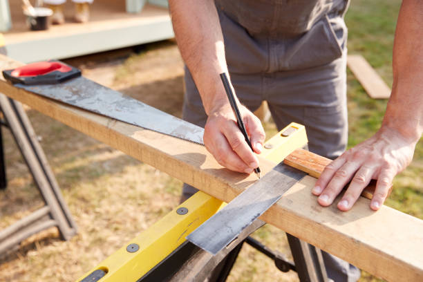istock Close Up Male Carpenter Measuring Wood Using Set Square Outdoors 1205229946