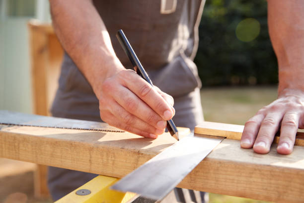 istock Close Up Male Carpenter Measuring Wood Using Set Square Outdoors 1205230548