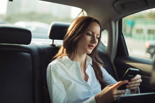 istock Business woman using mobile in car 1205232167