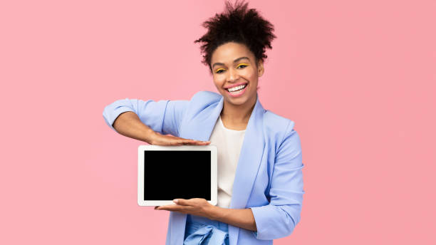 istock Happy black woman showing black blank computer screen 1205232539