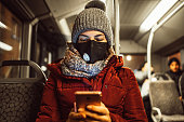 Woman in bus wearing face mask