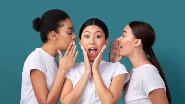istock Three Girls Friends Gossiping Sharing Rumors Standing In Studio, Panorama 1205233295