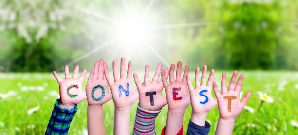istock Children Hands Building Word Contest, Grass Meadow 1205233727